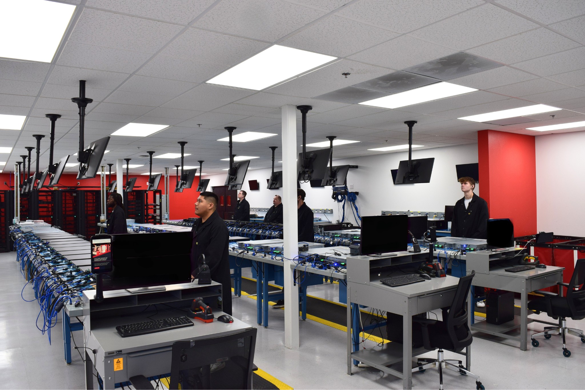 Velasea configuration lab with tables of servers and workstations being built by engineers